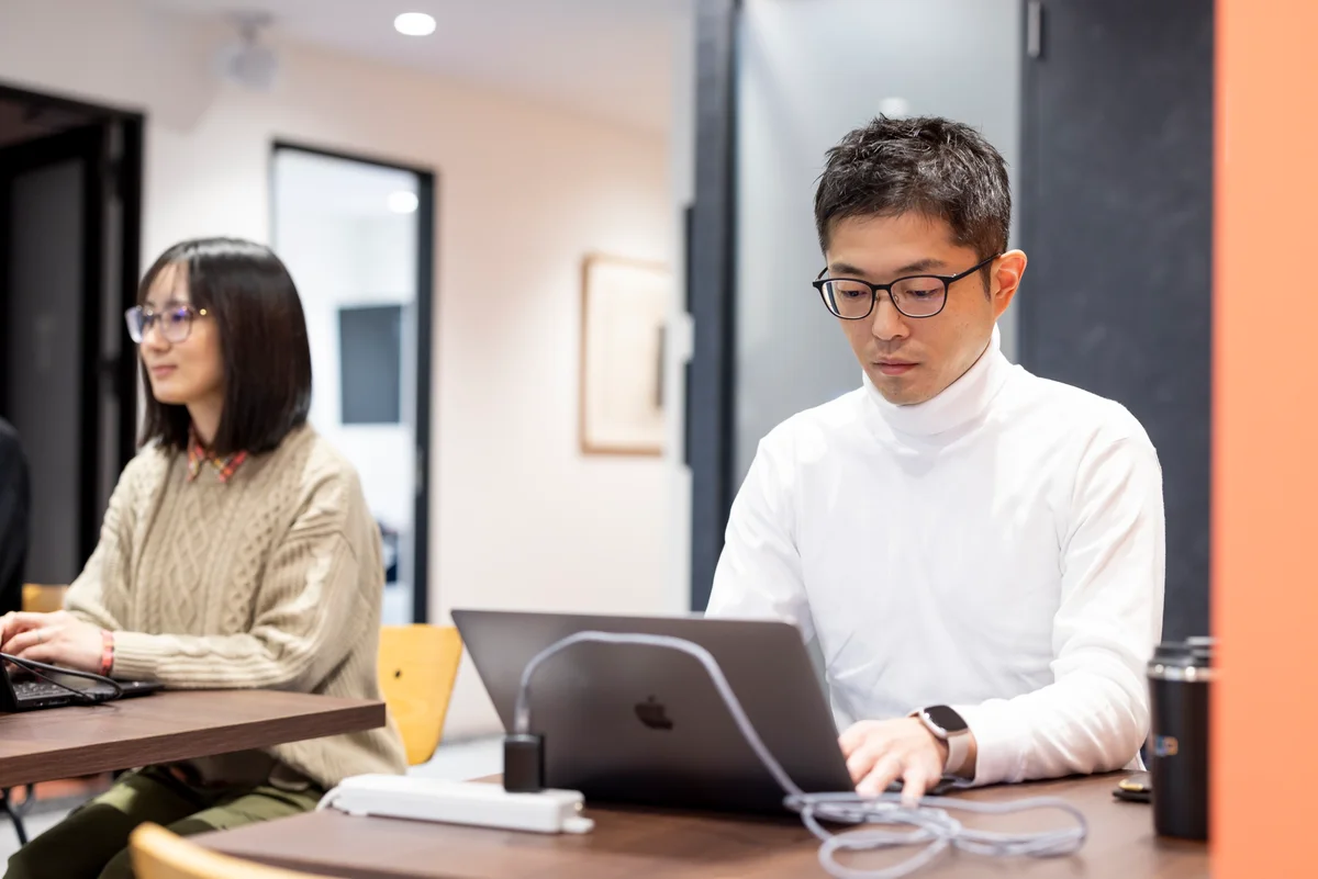 並んだデスクでそれぞれの仕事に取り組む様子
